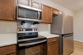 Kitchen with a stainless steel refrigerator and a black oven.
